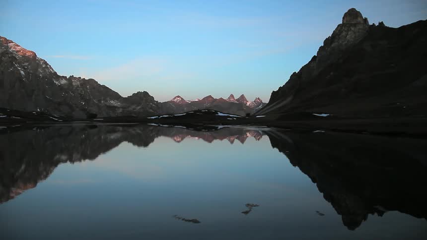 Reflections of mountains on a still lake