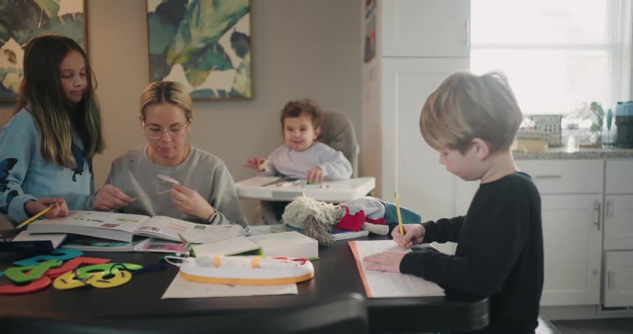 A mother teaching her children in their kitchen