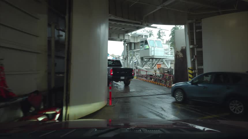 Personal vehicles move out of a building and onto a road in a city