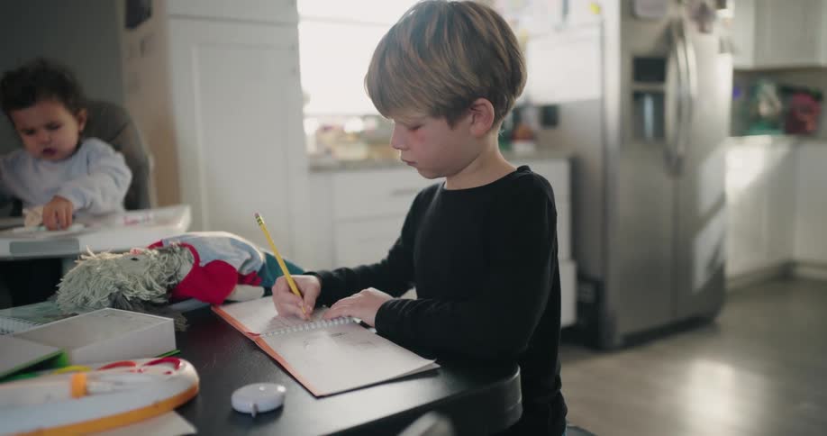 A child is writing in his notebook