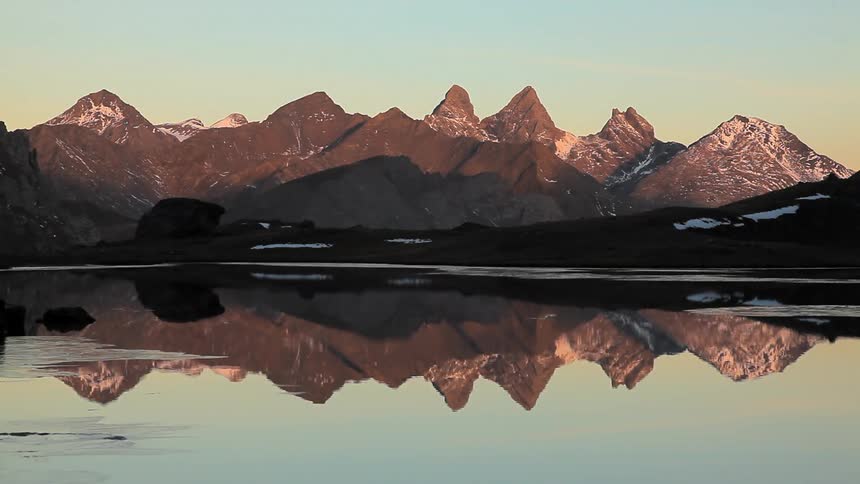 Reflections of mountains on a still lake