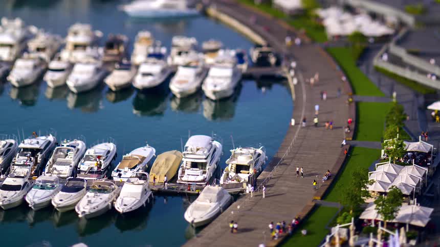 Time lapse of people walking on a path along the marina