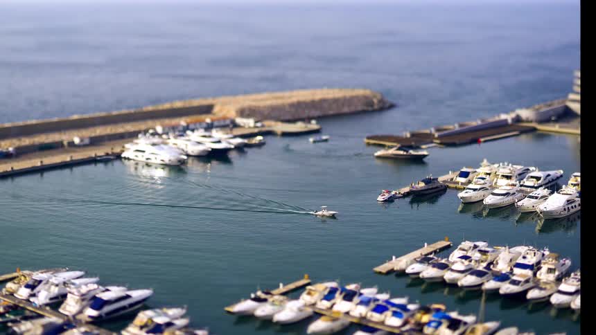 Yachts parked on a pier in the sea