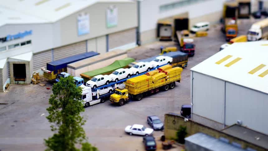 Moving vehicles including cars and trucks in a logistics center