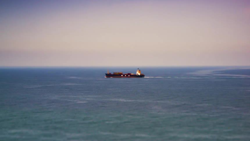 A freighter travels in the ocean