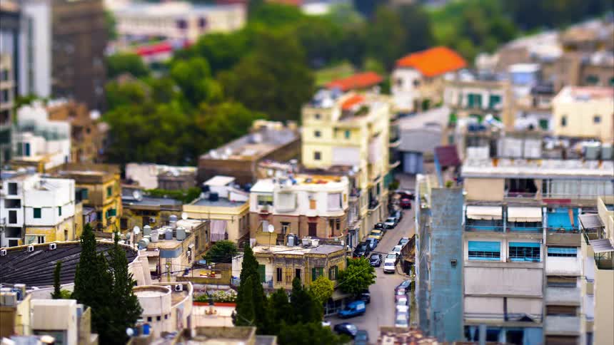 Vehicles drive down the small roads in the city