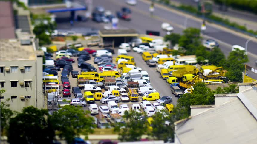 Parking with vehicles next to a busy highway