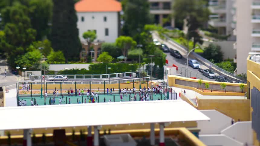Panorama of a city with a sports court with a crowd of people