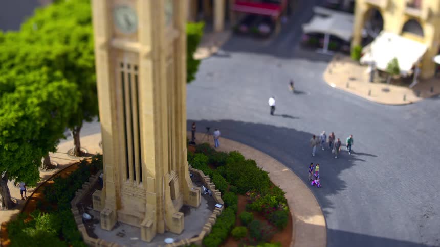 Tourists walk around the clock tower