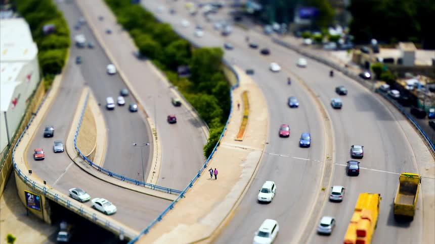 Traffic runs on the freeway during the day