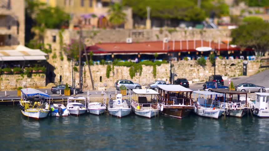Marina with parked boats and vehicle traffic in the background
