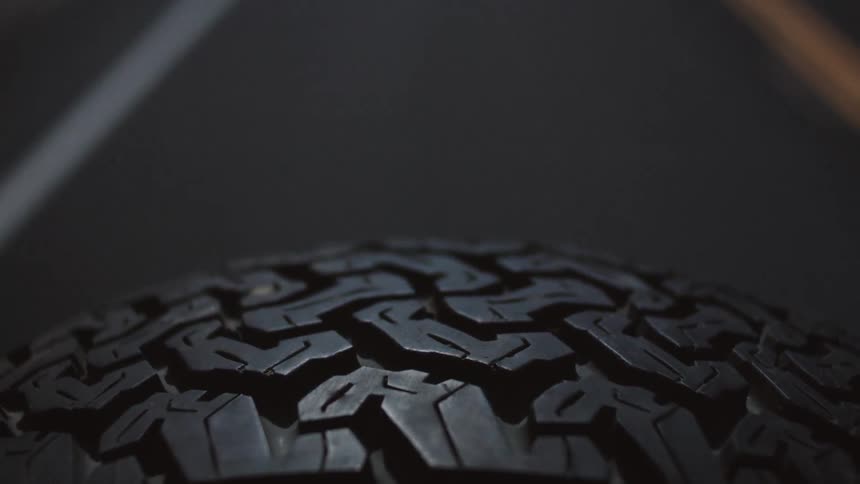 Road passing beneath spare wheel's tire tread