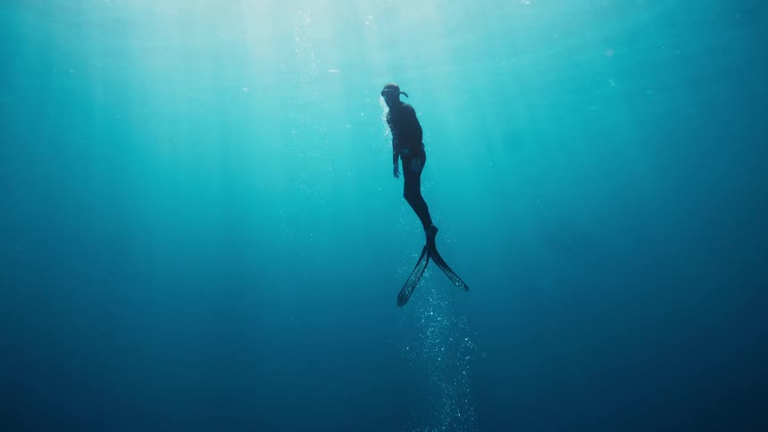 People are diving and swimming underwater
