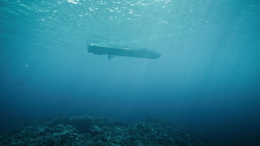 An underwater perspective shows a boat floating on the surface