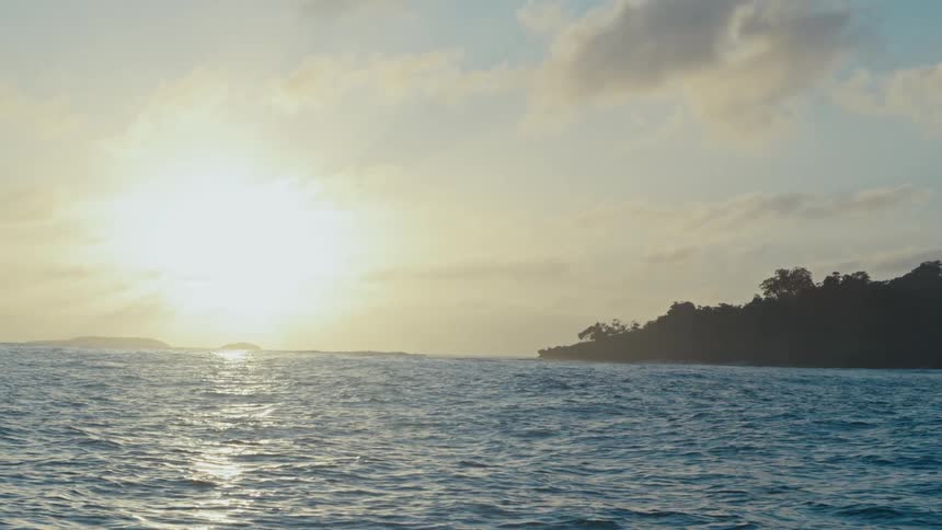 Landscape of a calm ocean with the sun on the horizon