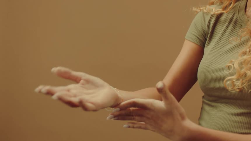A woman is modeling some gold bracelets
