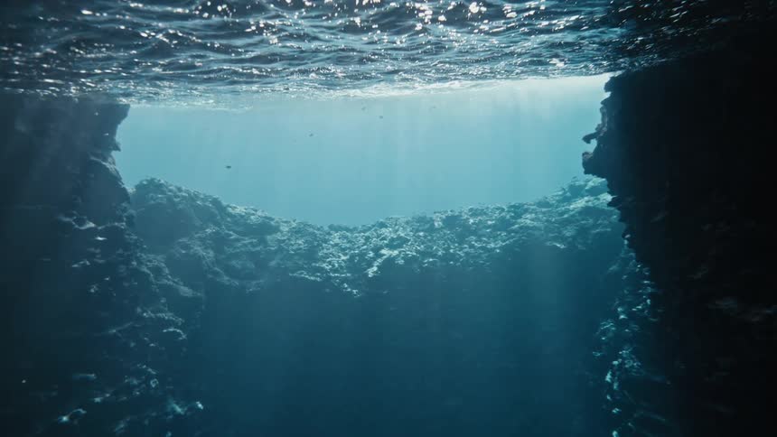 Bright sunlight is shining above the ocean water