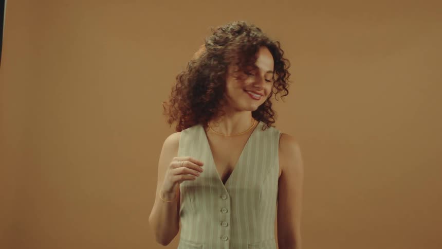A footage of a lady smiling and posing for pictures
