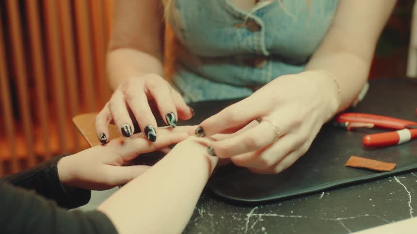 Pair of hands examining the wrist of a woman wearing a bracelet