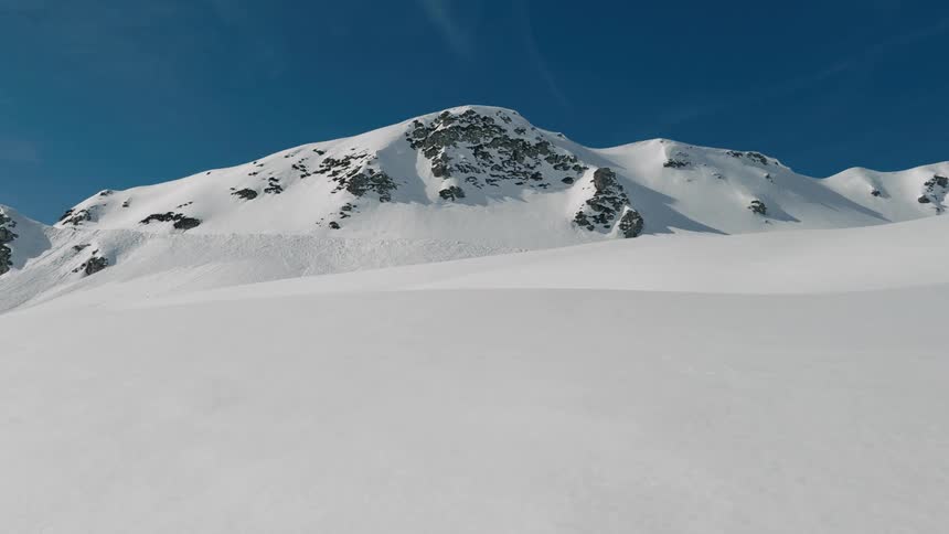 Snow and ice are covering the tops of the mountain range