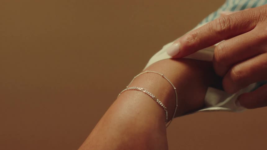 A woman is modeling a silver bracelet