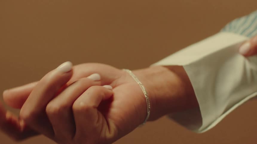 A woman wearing a long sleeve shirt is modeling a bracelet