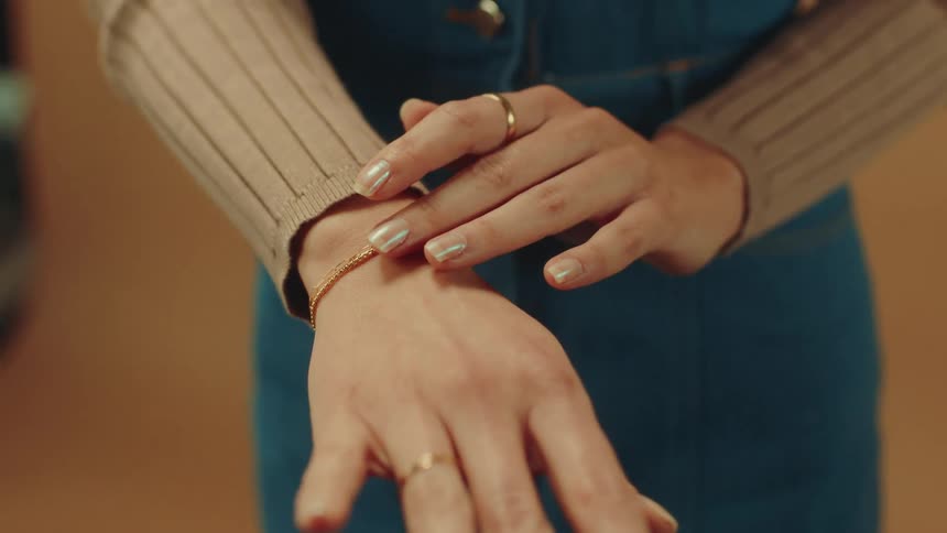 Womans hand and arm with a ring and bracelet