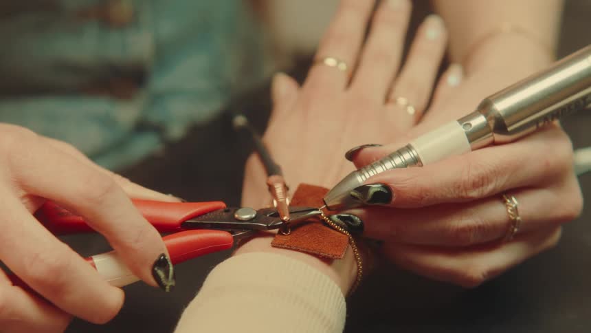 A clip of a goldsmith working on a hand bracelet