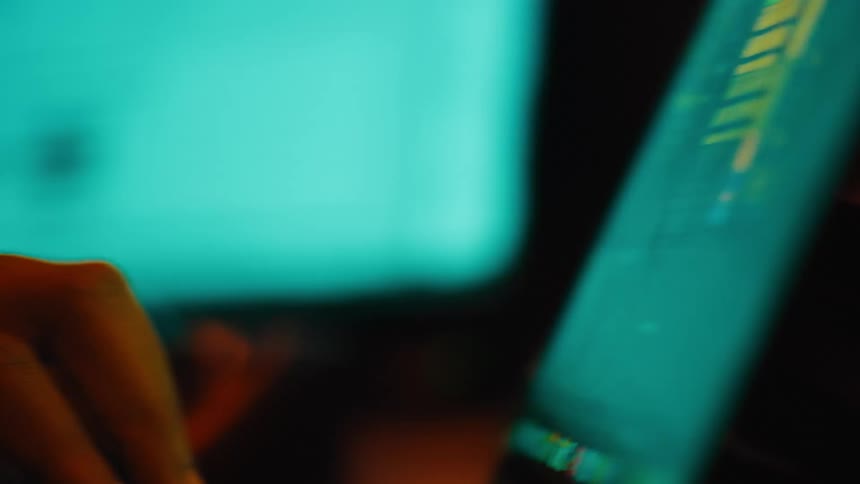 A person is typing on their laptop