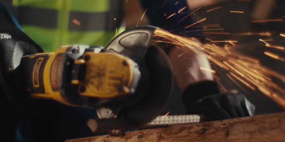 A construction worker is using an electrical saw