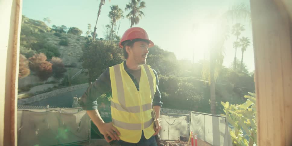 A construction worker looks at the home frame