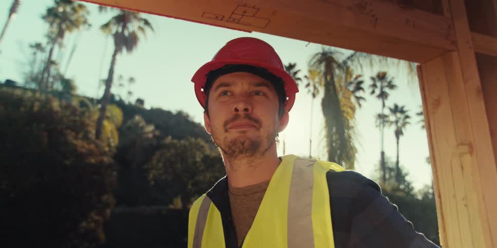 A man looks at the frame for a home