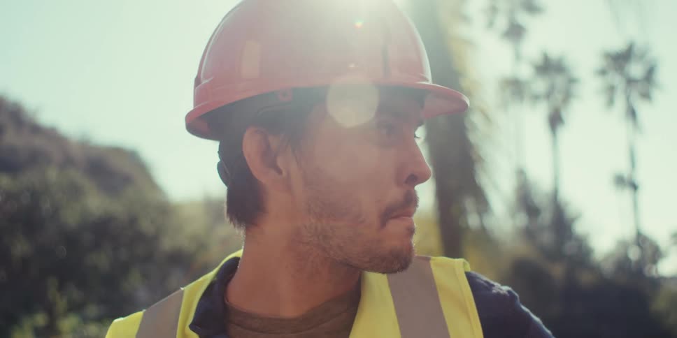 Construction worker is using a hammer while working on the jobsite