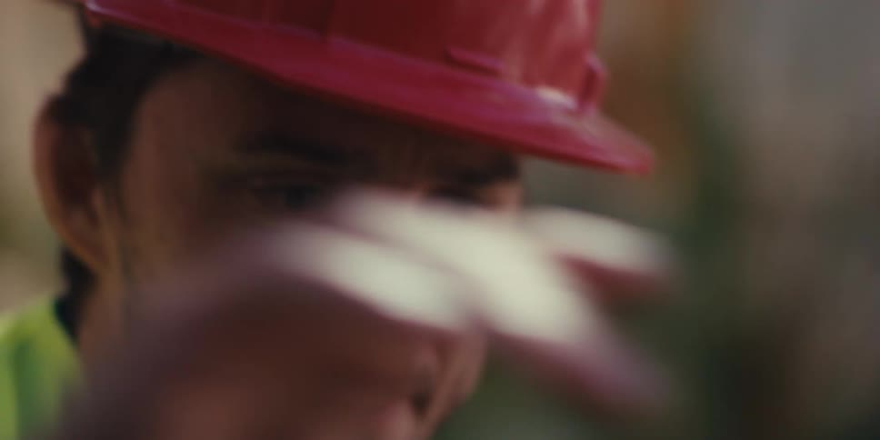 The construction worker is using a level on the frame