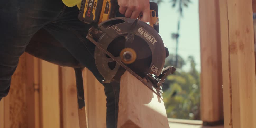 Cutting a two by four wood piece with a circular saw on a job site