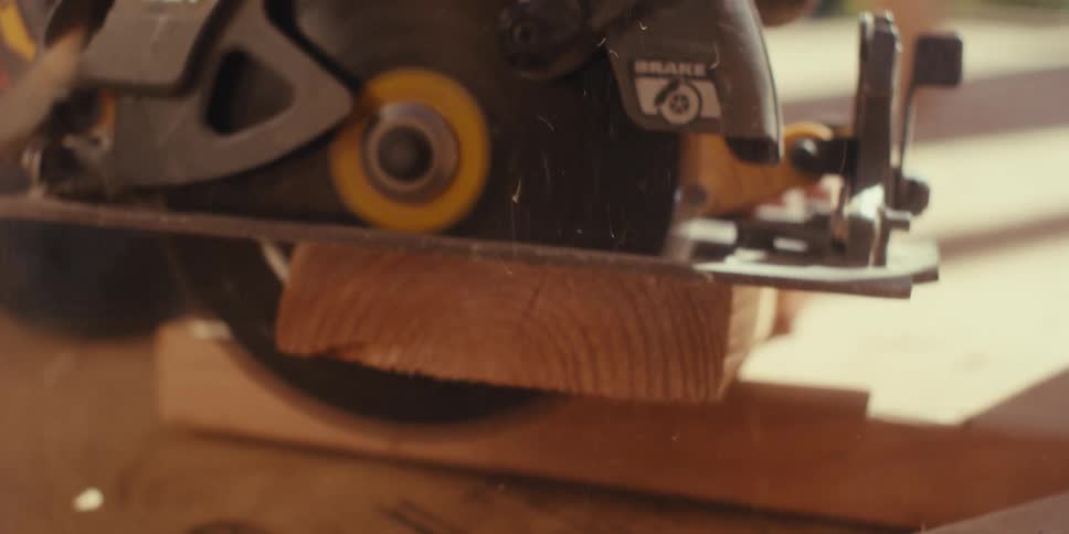 Contractor cutting wood with a circular saw on job site