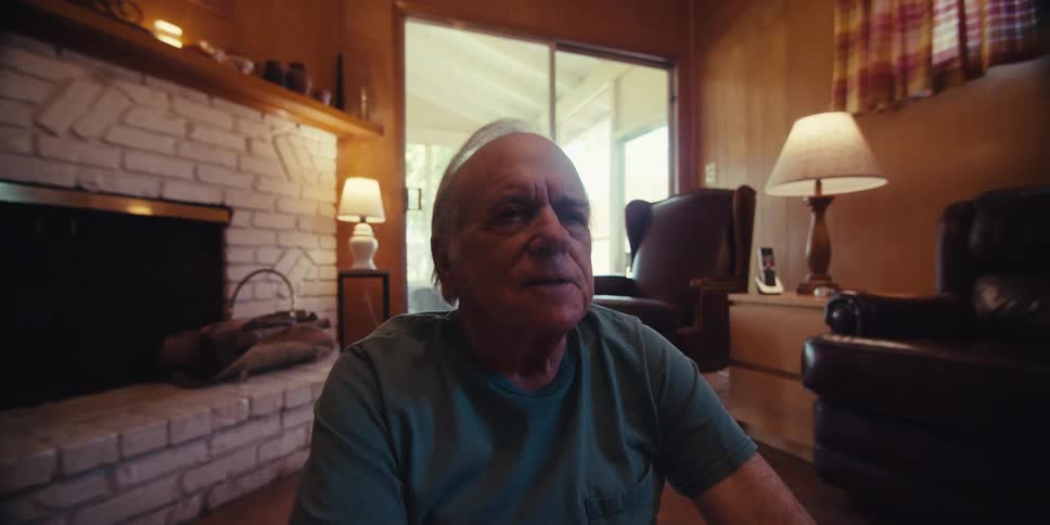Elderly man is doing a yoga pose in his living room