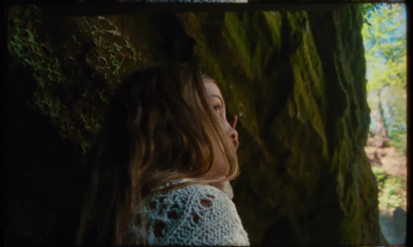 Teenager walking in a natural area and looking around carefully