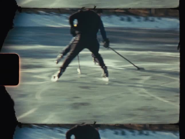 Friends playing hockey on a frozen pond outdoors in the winter
