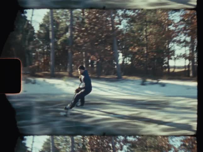 Man playing hockey on an outdoor ice rink with trees around