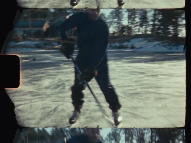 Boy playing hokey in an icy rink outside
