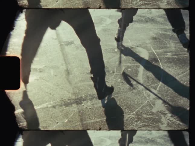 Two people playing a game of hockey