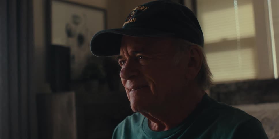 Elderly man sitting with happy facial expression