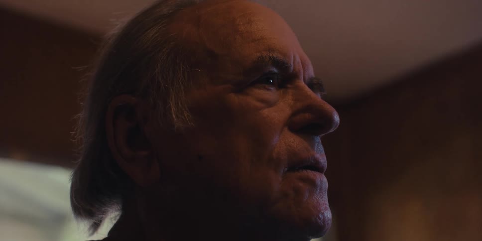 Elderly man practicing breathing excersises in his living room