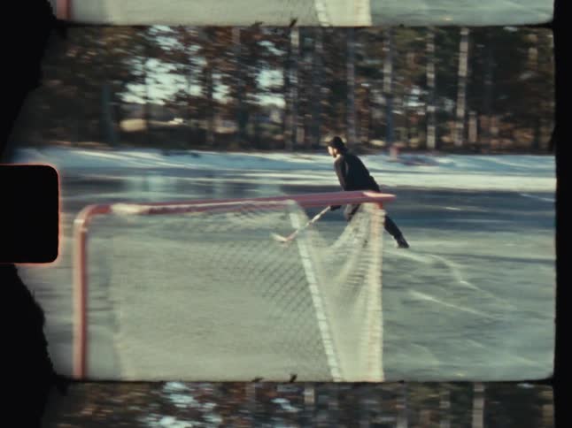 A man shoots and scores playing ice hockey