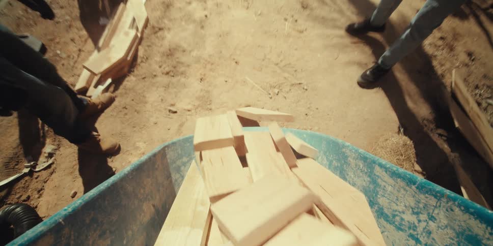 Wood is poured out of the wheelbarrow
