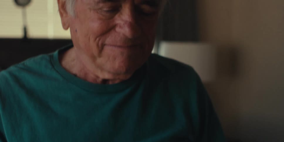 A man looks at his tablet and smiles
