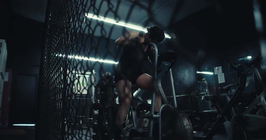 Woman in a gym using an exercise bike at high intensity