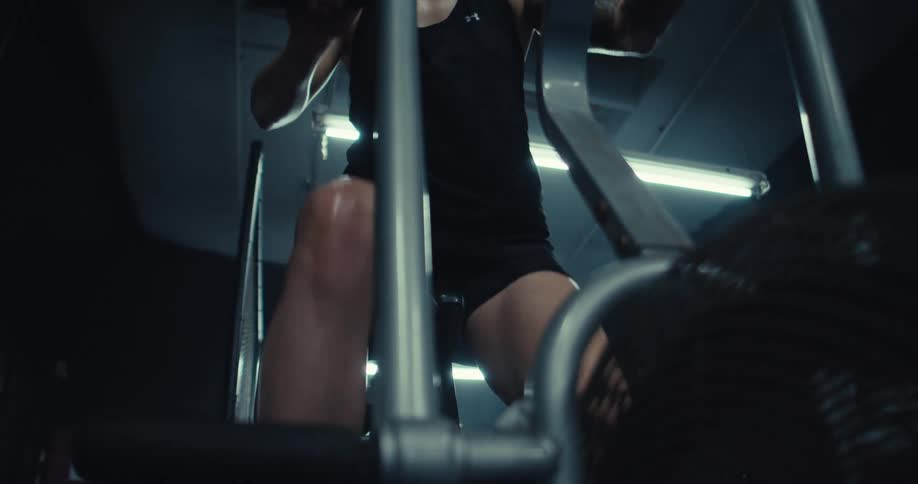 A woman is sweating as she pedals in the gym