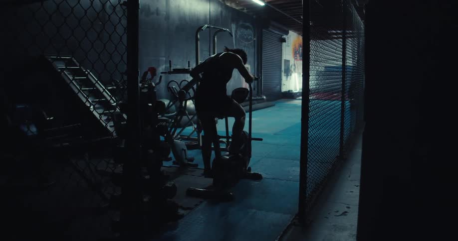 A woman is sweating as she pedals on the exercise bike